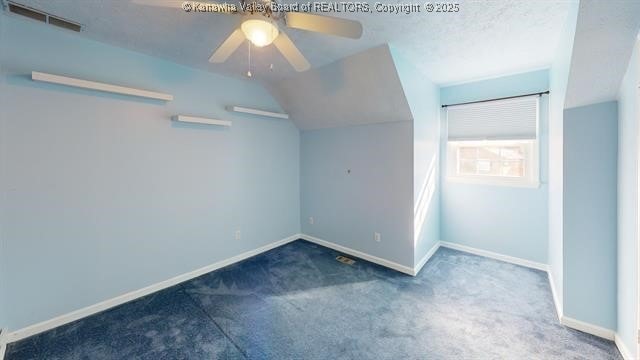 additional living space featuring vaulted ceiling, carpet flooring, visible vents, and baseboards