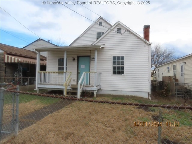 view of front of home featuring a front yard and a porch