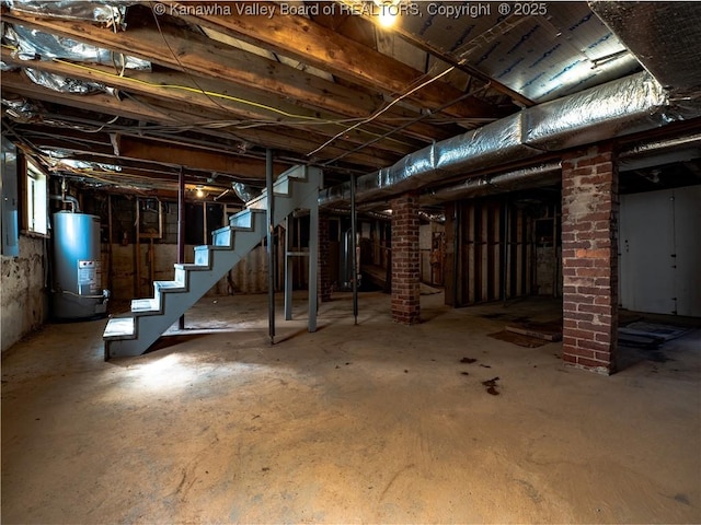 basement featuring electric panel and gas water heater