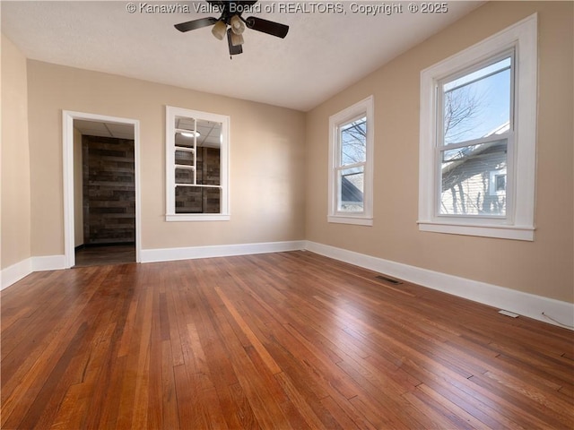 empty room featuring ceiling fan and dark wood-type flooring