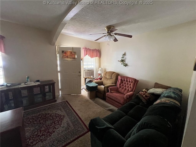 living room with a textured ceiling, ceiling fan, carpet flooring, and cooling unit