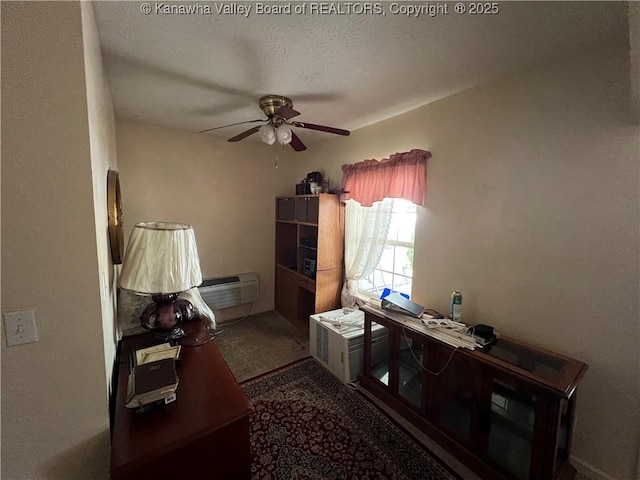 interior space with a textured ceiling, ceiling fan, and a wall mounted air conditioner