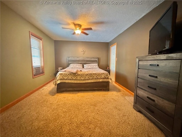 carpeted bedroom featuring a textured ceiling and ceiling fan