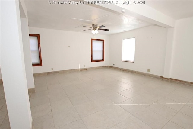 tiled spare room with ceiling fan