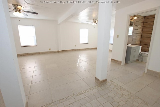 unfurnished room featuring ceiling fan and light tile patterned flooring