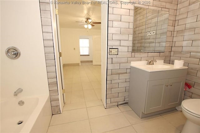 full bathroom with tile patterned flooring, vanity, tile walls, and ceiling fan