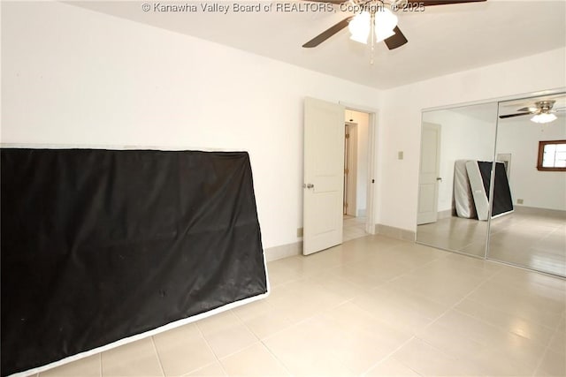 interior space featuring light tile patterned floors, a closet, and ceiling fan