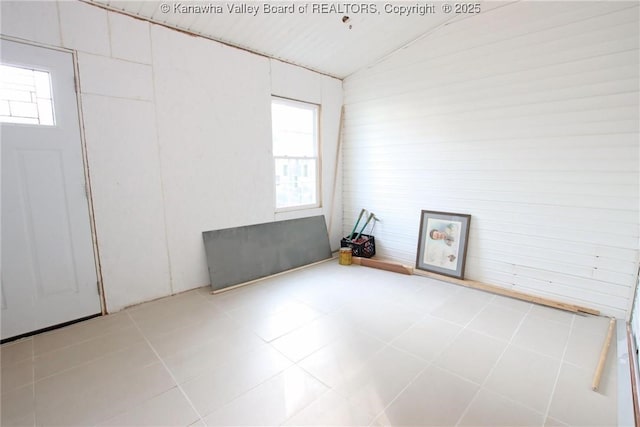 empty room featuring lofted ceiling