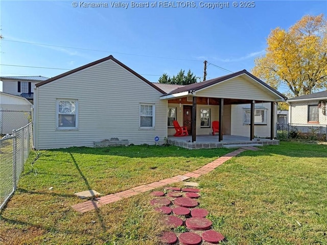 rear view of property with a yard and covered porch