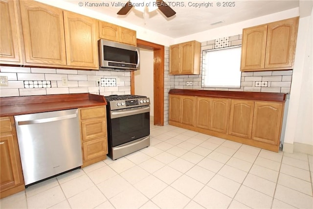 kitchen featuring decorative backsplash, stainless steel appliances, ceiling fan, and light tile patterned flooring