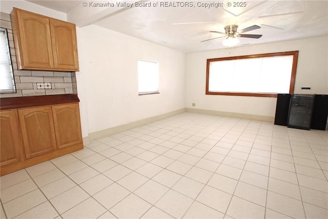 interior space with light tile patterned flooring and ceiling fan