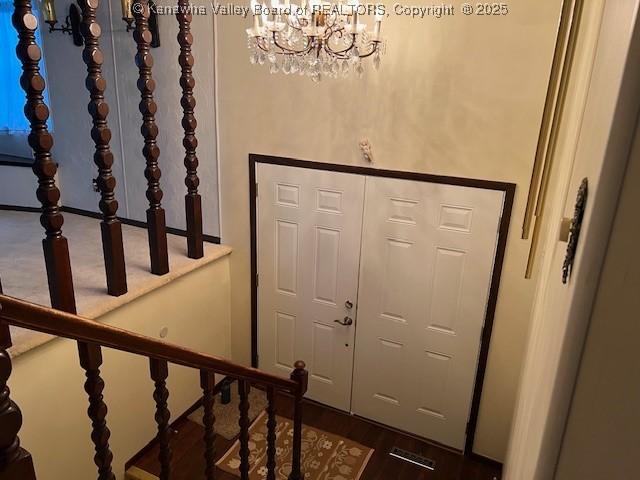 entryway with a notable chandelier