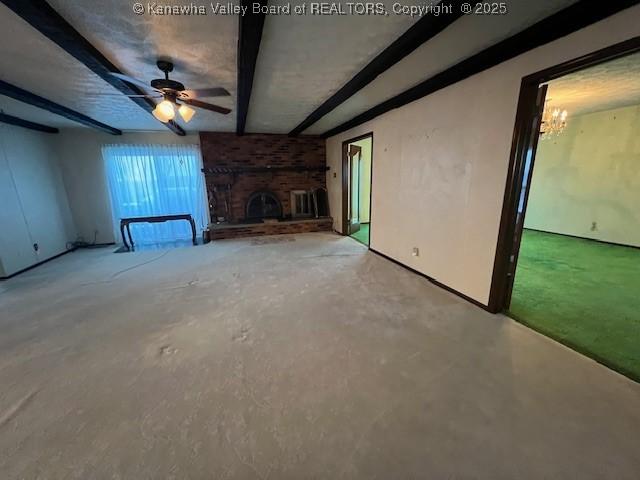 unfurnished living room featuring concrete flooring, a brick fireplace, and ceiling fan