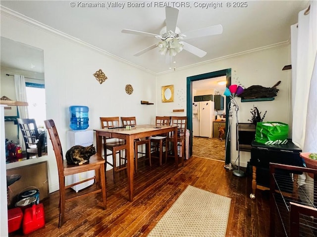 dining area featuring dark hardwood / wood-style floors, ceiling fan, and ornamental molding