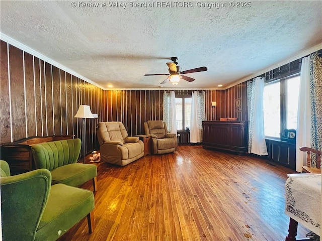 living area with hardwood / wood-style flooring, a textured ceiling, and plenty of natural light