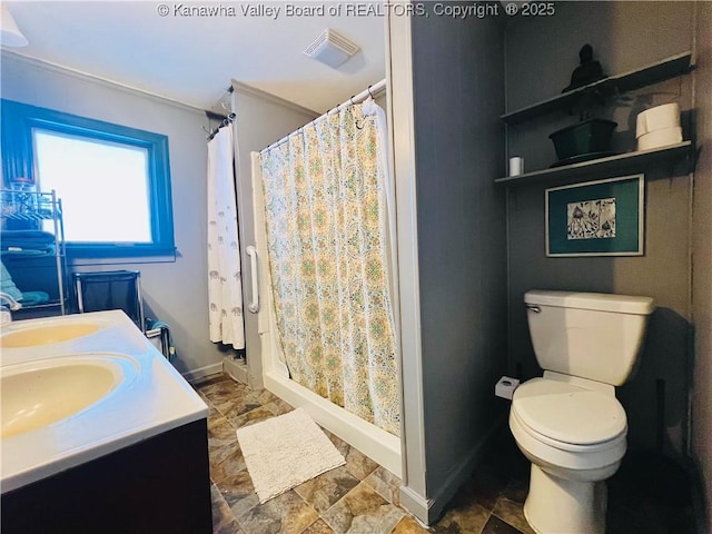 bathroom with toilet, vanity, and a shower with curtain