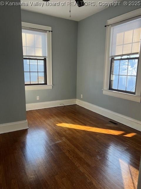 empty room featuring dark hardwood / wood-style flooring