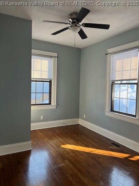 empty room featuring ceiling fan and dark wood-type flooring