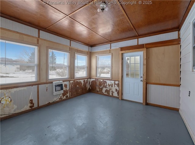 unfurnished sunroom with wood ceiling and heating unit