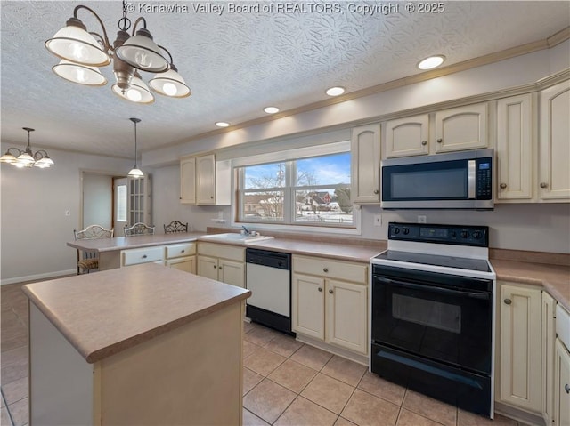 kitchen with hanging light fixtures, appliances with stainless steel finishes, cream cabinets, and kitchen peninsula