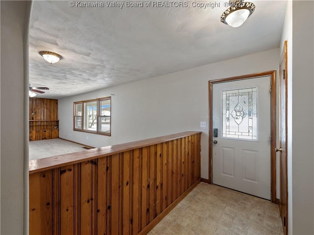 entrance foyer with ceiling fan