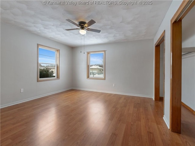 unfurnished bedroom featuring light wood-type flooring and ceiling fan