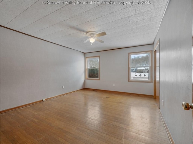 empty room featuring crown molding, ceiling fan, and light hardwood / wood-style floors