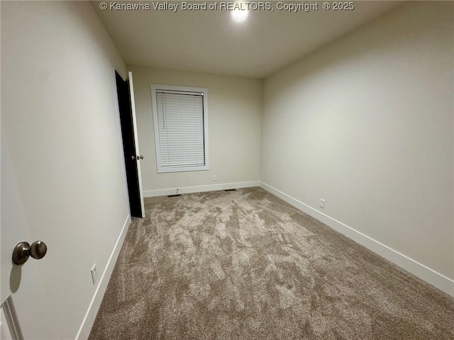 unfurnished room featuring light colored carpet