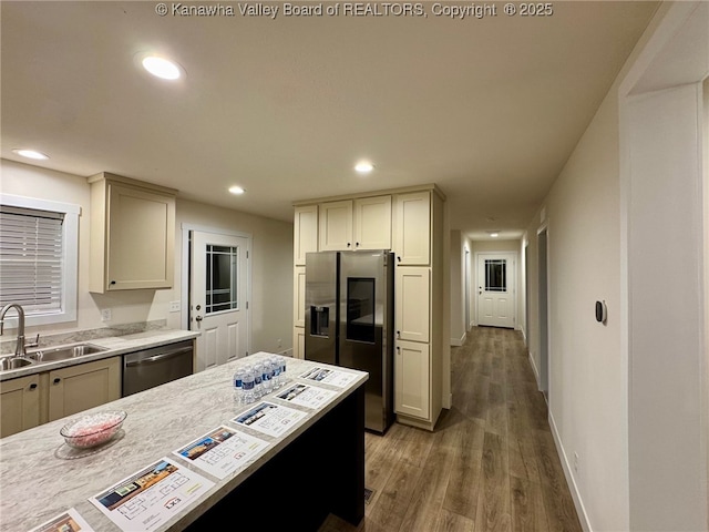 kitchen with sink, dark wood-type flooring, cream cabinets, and appliances with stainless steel finishes