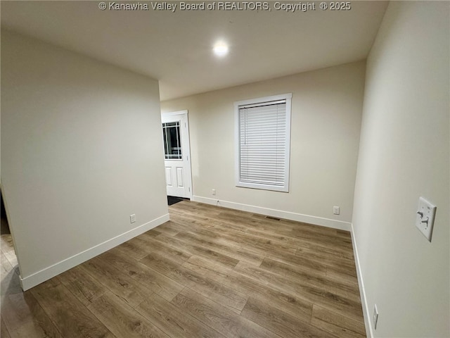 unfurnished room with light wood-type flooring