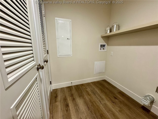 clothes washing area featuring dark wood-type flooring, washer hookup, and electric panel