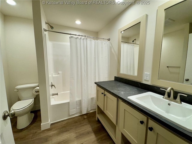 full bathroom with wood-type flooring, vanity, shower / tub combo with curtain, and toilet