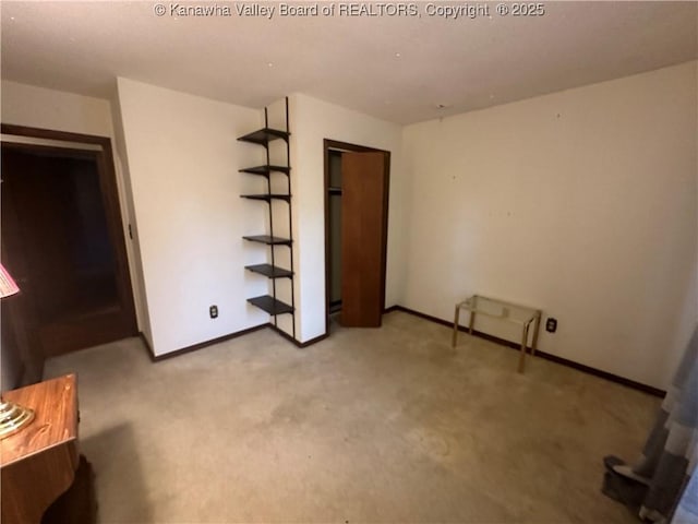 unfurnished bedroom featuring light colored carpet and a closet