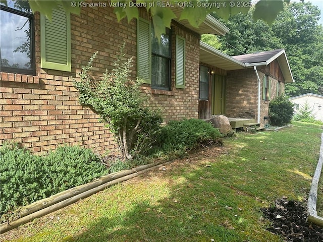 view of side of property with a yard