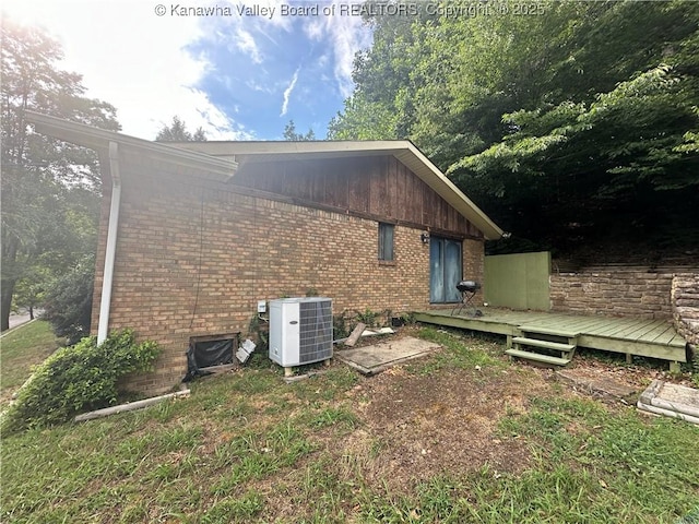 view of home's exterior with cooling unit and a deck