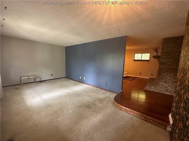 carpeted spare room with a textured ceiling