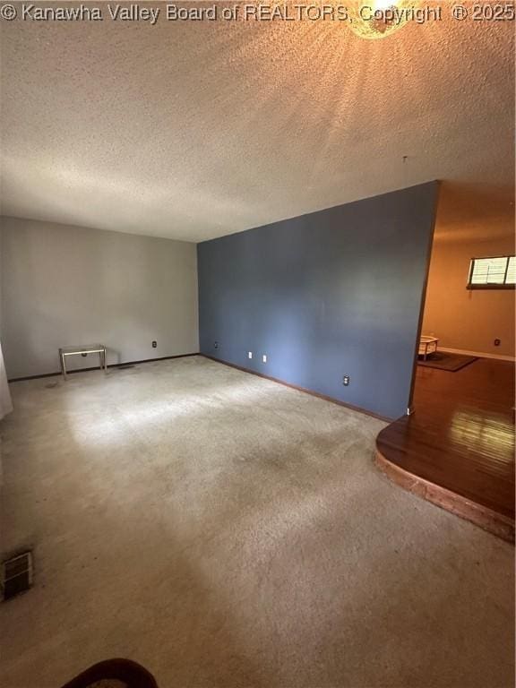 empty room featuring carpet floors and a textured ceiling