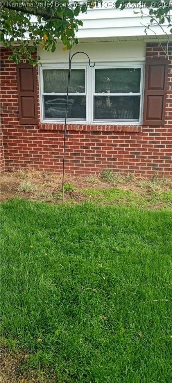 view of side of home featuring a yard