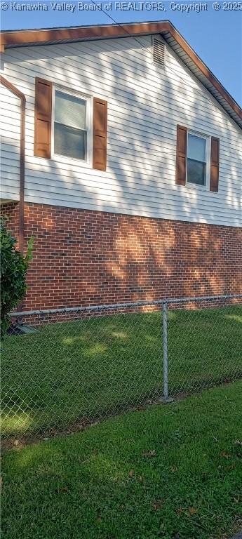 view of side of home featuring a lawn