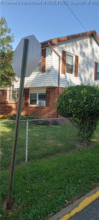 view of side of home with a lawn