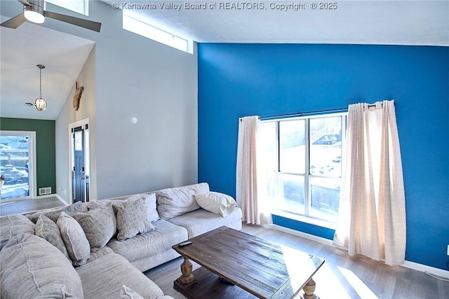 living room featuring hardwood / wood-style flooring and high vaulted ceiling