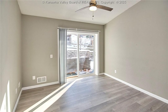 empty room featuring ceiling fan and light hardwood / wood-style floors