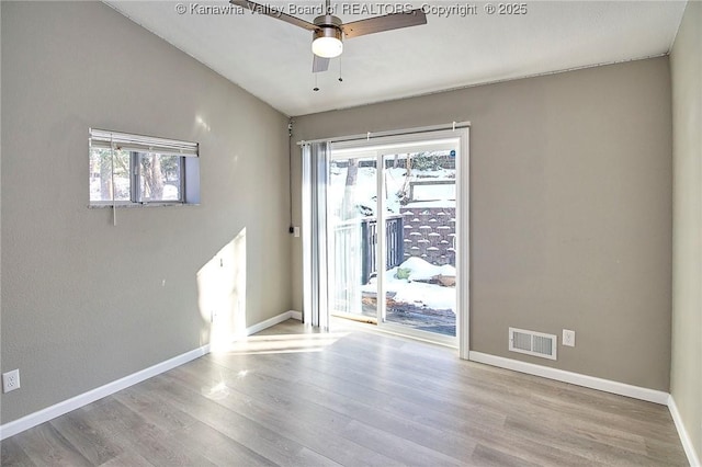 spare room with lofted ceiling, ceiling fan, and light hardwood / wood-style flooring