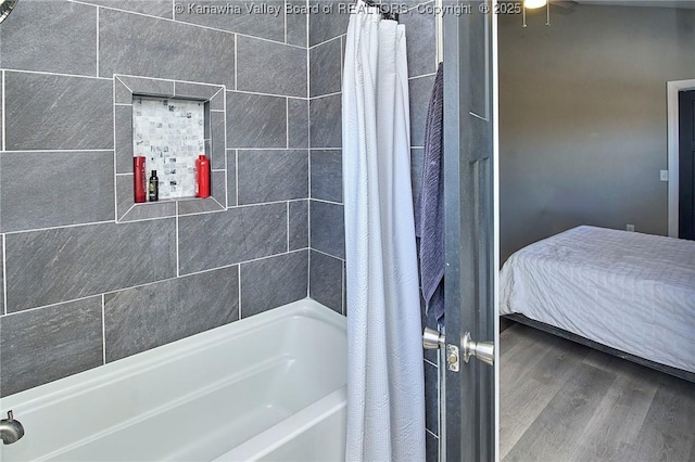 bathroom featuring wood-type flooring and shower / bath combination with curtain