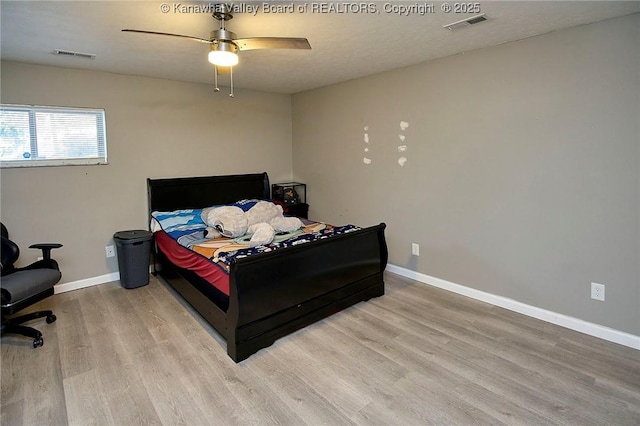 bedroom with ceiling fan and light hardwood / wood-style floors