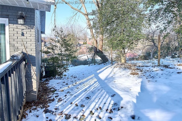 view of yard layered in snow