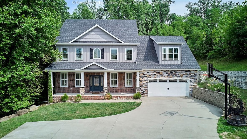 craftsman house with a garage, covered porch, and a front lawn