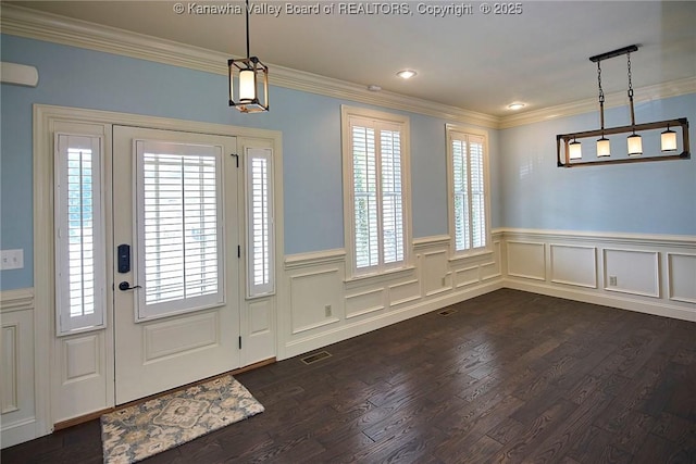 entryway with dark hardwood / wood-style flooring, crown molding, and a healthy amount of sunlight