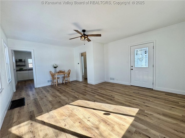 foyer entrance with ceiling fan and dark hardwood / wood-style floors