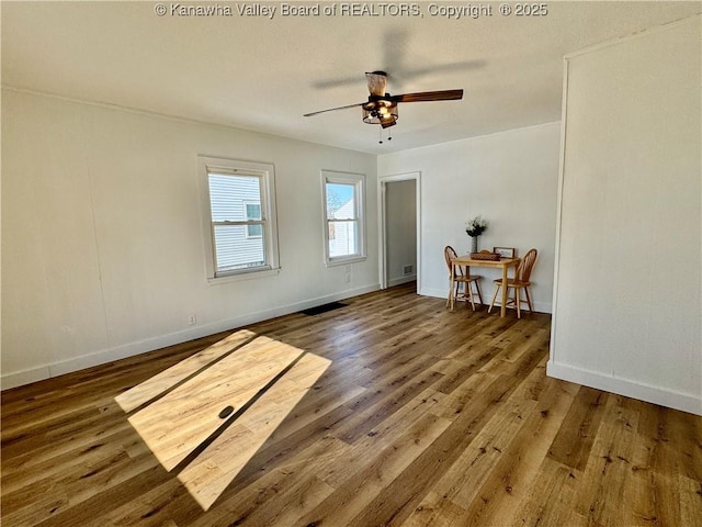 unfurnished room featuring ceiling fan and dark hardwood / wood-style flooring